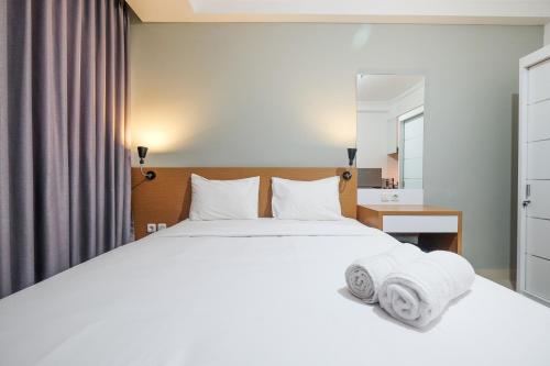 Ένα ή περισσότερα κρεβάτια σε δωμάτιο στο Warm and Relax Studio at Signature Park Grande Apartment By Travelio