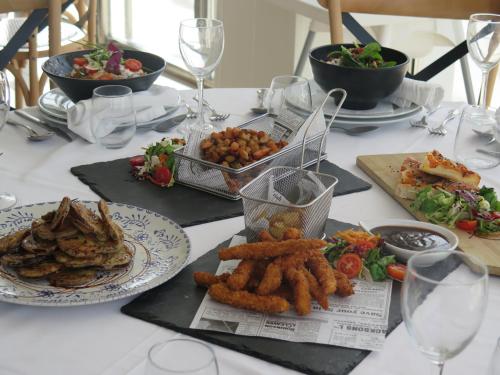 a white table with plates of food on it at Hotel Restaurante Boabdil in Otura