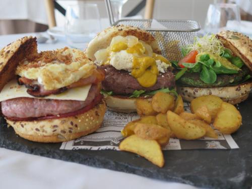a plate of sandwiches and potatoes on a table at Hotel Restaurante Boabdil in Otura