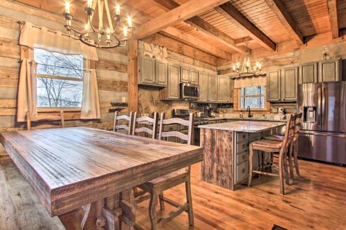 a kitchen with a large wooden table in a cabin at Spacious Gatlinburg Cabin with Hot Tub and Game Room! in Gatlinburg