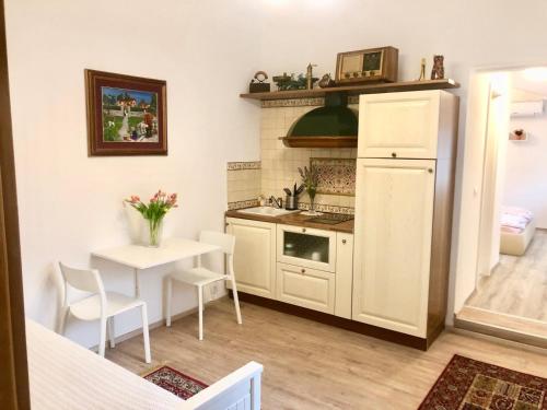 uma pequena cozinha com uma mesa e um frigorífico em Apartments Maria em Ljubljana