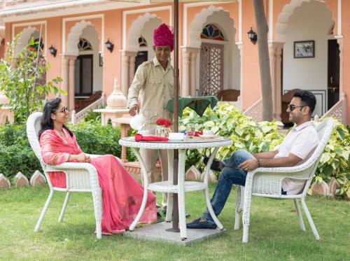a man and a woman sitting at a table at Tree of Life Inderpura Resort Udaipurwati in Jhunjhunūn