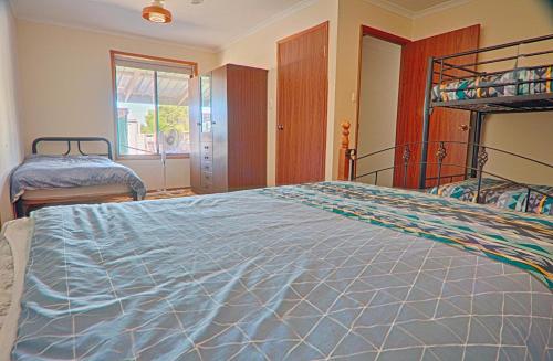 En eller flere senge i et værelse på Smoky Bay Holiday Home