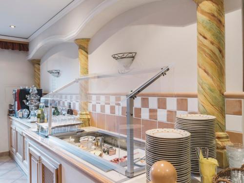 a kitchen with a counter with plates on it at Stiegenwirt in Palfau