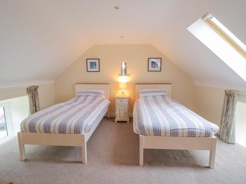 Postel nebo postele na pokoji v ubytování Plas Tirion Cottage