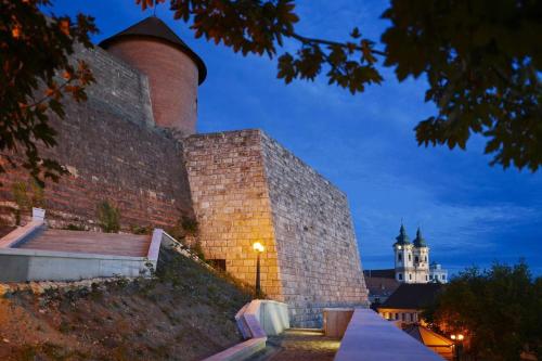 a large brick wall with a tower on top of it at Borostyán Vendégház Eger in Eger