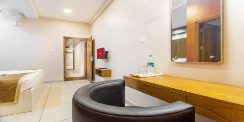 a bathroom with a black tub in a room at Nextel Inn, Calicut in Kozhikode