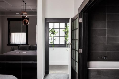 a bedroom with a door leading to a bedroom with a bed at St Kilda Beachfront Penthouse in Melbourne