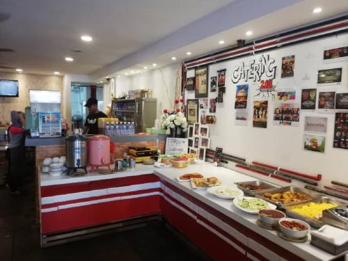 a restaurant with a counter with food on it at M Design Hotel @ Pandan Indah in Kuala Lumpur