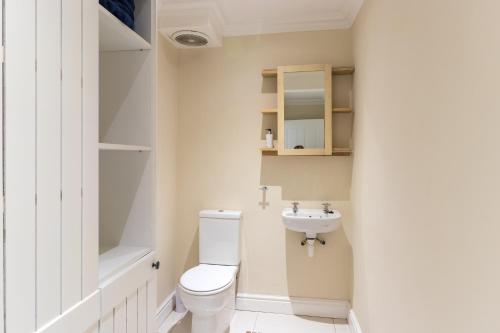a bathroom with a toilet and a sink at The Lookout Guest House in Port Alfred