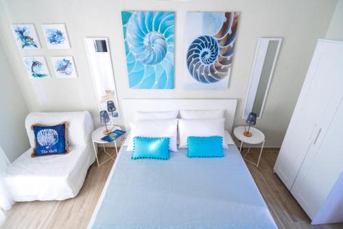 a living room with a couch and blue pillows at Sea Breeze Vibes in Nea Peramos