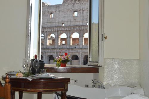 a bathroom with a view of the coliseum in a mirror at jacuzzi in front of the colosseum in Rome