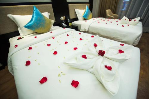 a couple of beds with hearts on them at Le Chen Miiya Hotel in Sihanoukville