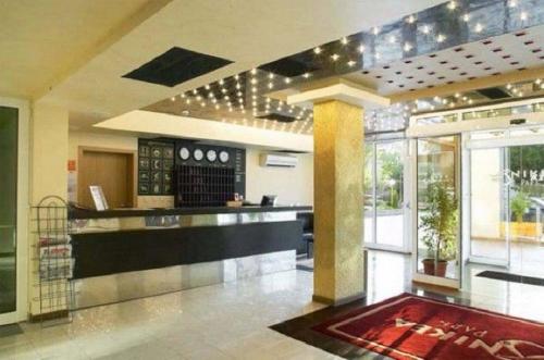 a lobby with a bar in a building at NikeaPark in Golden Sands