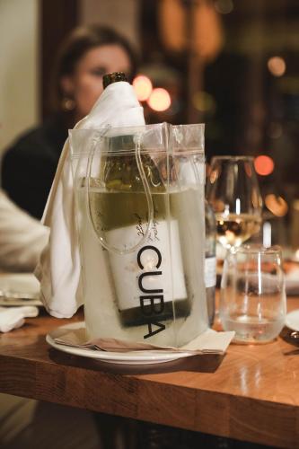 a bottle of wine sitting on top of a table at Hotel Hostal Cuba in Palma de Mallorca