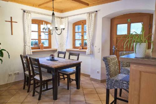 a dining room with a wooden table and chairs at Ferienpension Posthof in Waldmünchen