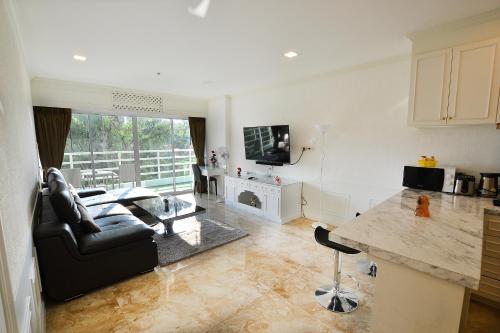 a living room with a couch and a table at View Talay 6 Pattaya Beach by CANDO in Pattaya