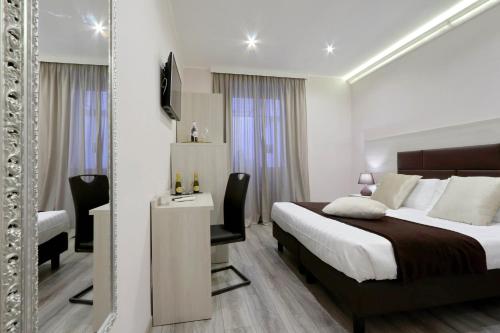 a hotel room with a bed and a mirror at Roma Suite Monti in Rome
