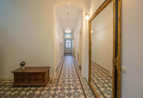 a hallway with a mirror and a table at Boutique Appartement-Hotel Villa Juttershof in Bergen