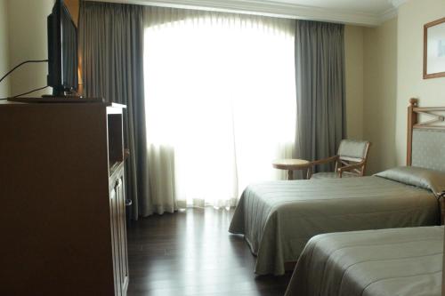 Cama o camas de una habitación en The Grand Dame Hotel