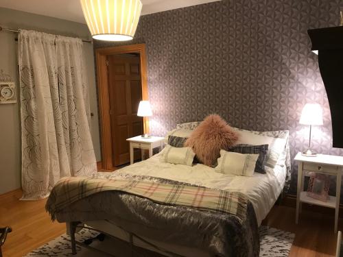 a bedroom with a bed and two tables with lamps at Forest View - Castlewellan, County Down in Belfast