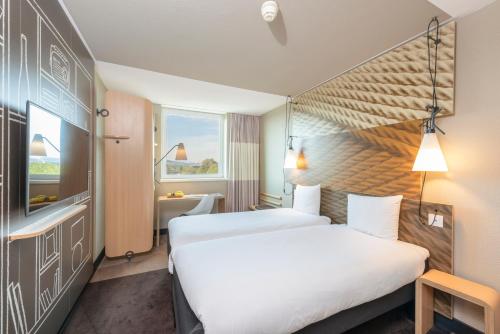 
Ein Bett oder Betten in einem Zimmer der Unterkunft ibis Bern Expo
