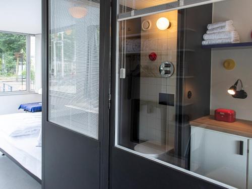 a bathroom with a shower with a glass door at SWEETS - Hortusbrug in Amsterdam