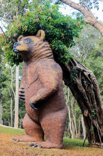 a statue of a bear with a bush on its back at Minera Hot Springs Binh Chau in Binh Chau