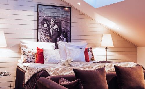 a bed with a dog sitting on top of it at Arctic Light Hotel in Rovaniemi