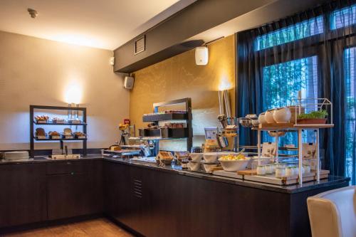 a kitchen with a counter with food on it at Hotel & Spa Savarin - Rijswijk, The Hague in Rijswijk