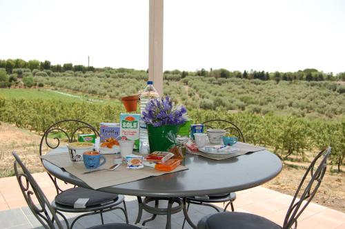 a gray table with chairs and food on it at Mandorleo in Belpasso