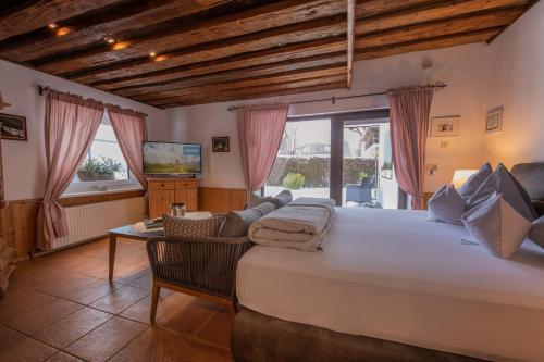 a large bedroom with a large bed and a television at Chalet Stubai inklusive Stubai Super Card in Fulpmes