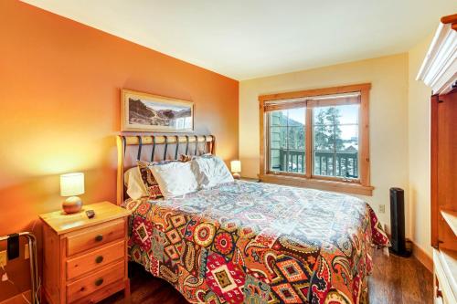 a bedroom with a bed and a window at Expedition Station in Keystone