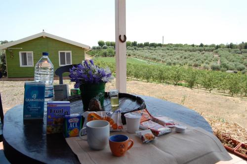 a table with food and drinks and a bottle of water at Mandorleo in Belpasso
