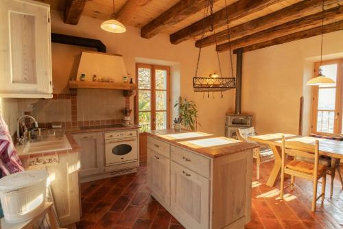 uma grande cozinha com armários brancos e uma mesa em Castellino Bella Vista em Ponte Tresa