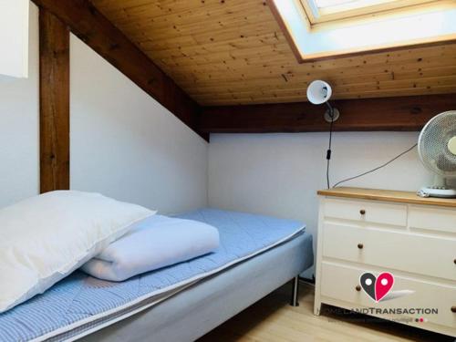 a small bedroom with a bed and a dresser at OCELANDES 86 in Saint-Julien-en-Born