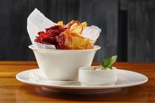 a bowl of food on a plate on a table at Hotel Ungar in Svitavy