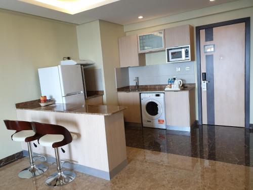a kitchen with a counter and a washer and dryer at Best Western Plus Mahboula in Kuwait