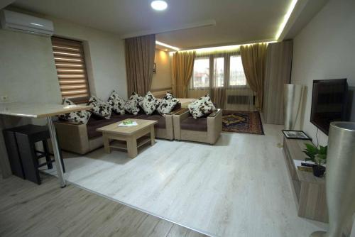 a living room with a couch and a table at Cross Apartments and Tours in Yerevan