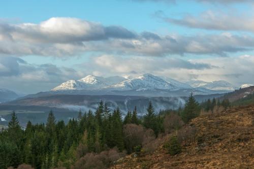 a mountain range with snow covered mountains in the distance at Lann Dearg Studios in Invermoriston