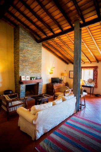 a large living room with couches and a fireplace at Casa dos Castelejos in Guerreiro