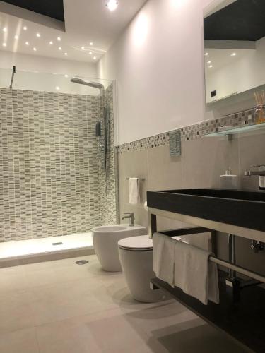 a bathroom with a sink and a toilet and a shower at B&B Rossini Luxury 2 in Cosenza