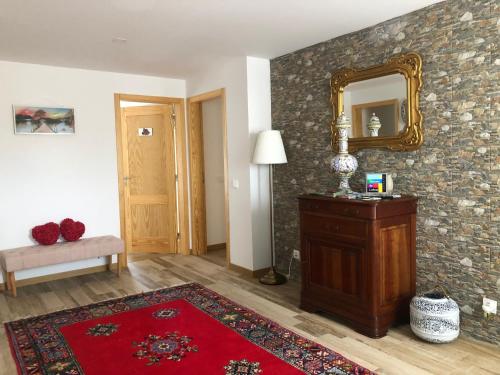 a living room with a mirror and a red rug at Terra Luso Proche De Montejunto in Cadaval