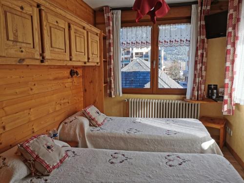 Postel nebo postele na pokoji v ubytování Hôtel Arolla