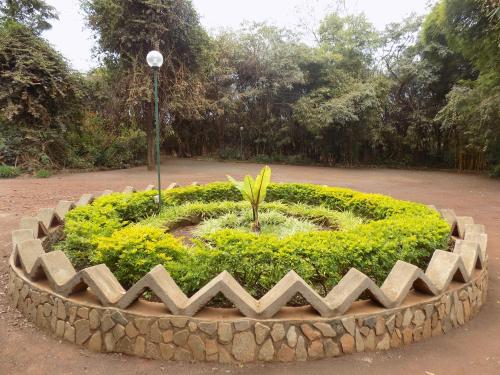 a large circle of flowers in a park at Octagon Lodge in Karatu