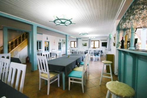 a dining room with a long table and chairs at ZEN Eco Villa in Sfântu Gheorghe