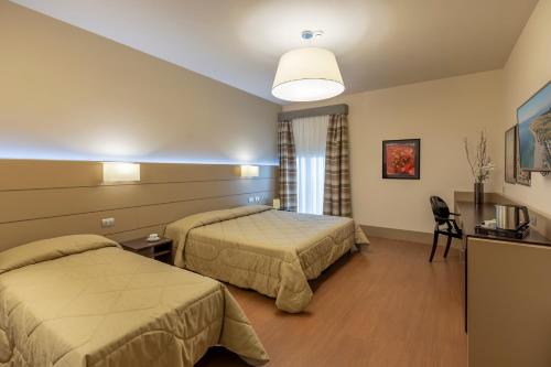 Postel nebo postele na pokoji v ubytování Hotel Vittoria