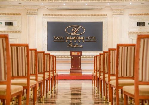 a row of chairs in a room with a stage at Swiss Diamond Hotel Prishtina in Pristina