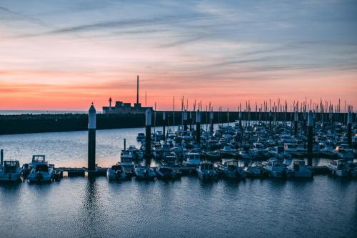 a group of boats docked in the water at sunset at Best Western ARThotel in Le Havre