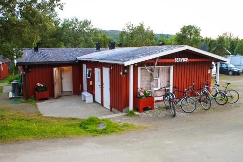 a red building with bikes parked outside of it at Lofoten Camp in Stamsund